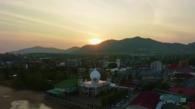 Aerial view Drone hyperlapse of light sunset or sunrise over mountains with seashore in Phuket thailand,Amazing sunset sky clouds over sea,Timelapse sky sunset evening time