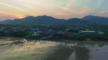 Aerial view Drone hyperlapse of light sunset or sunrise over mountains with seashore in Phuket thailand,Amazing sunset sky clouds over sea,Timelapse sky sunset evening time