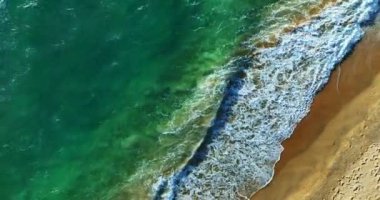 4K High quality footage Aerial view of Beautiful wave sea, White sea foam in tropical beach sea wave crashing on sandy shore empty beach in sunset or sunrise, Beautiful Phuket beach Thailand