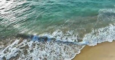 4K High quality footage Aerial view of Beautiful wave sea, White sea foam in tropical beach sea wave crashing on sandy shore empty beach in sunset or sunrise, Beautiful Phuket beach Thailand