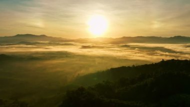 High angle view drone view of fog in rainy season over mountains,Beautiful sunrise sky clouds for create nature video scene. 4K High quality footage