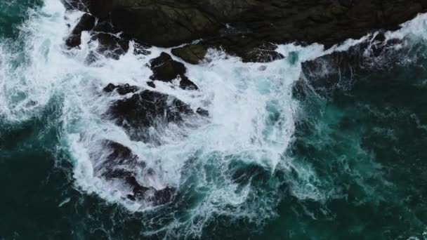 空中风景在漆黑的大海中 海浪在海滨岩石上流淌 海面上 海浪在岩石上波涛汹涌 奇形怪状 — 图库视频影像