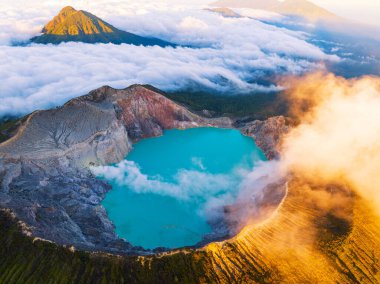 Kawah Ijen volkanındaki kayalık hava manzarası. Güneş doğarken turkuaz sülfür gölü. Endonezya, Doğu Java 'da doğa manzarası. Doğal manzara arka planı