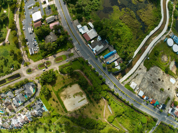 Aerial View of road with village in summer season, Top view Roofs of the houses Bird's-eye view of roads