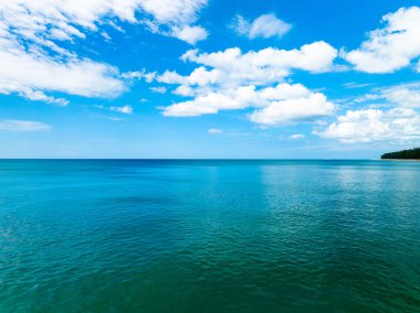 Aerial view of a blue sea surface water texture background,Sun reflections over ocean, Aerial flying drone view Waves water surface texture on sunny tropical ocean in Phuket island Thailand
