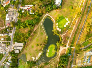 Aerial view drone shot of beautiful green golf field at Phuket island Thailand,Wide angle Top view golf course