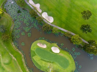 Yeşil golf sahasının hava manzarası spor arka planı ve seyahat için yukarıdan aşağıya görüntü, inanılmaz yeşil doğa manzarası.