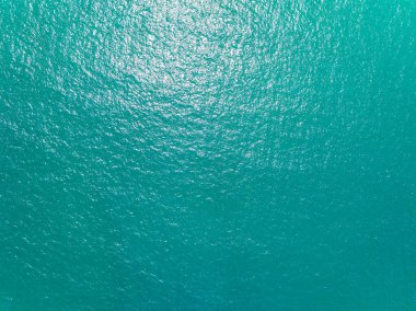 Aerial view of a blue sea surface water texture background,Sun reflections over ocean, Aerial flying drone view Waves water surface texture on sunny tropical ocean in Phuket island Thailand