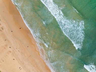 Aerial view sandy beach and big waves crashing on sandy shore, Beautiful tropical sea in the morning summer season image by Aerial view drone shot, high angle view Top down