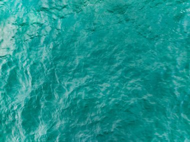 Aerial view of a blue sea surface water texture background,Sun reflections over ocean, Aerial flying drone view Waves water surface texture on sunny tropical ocean in Phuket island Thailand