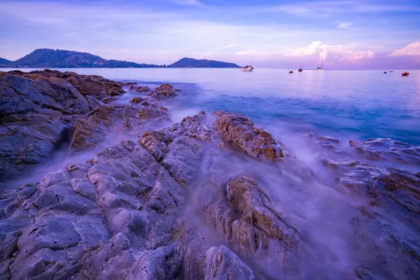 stock image Long exposure image of Dramatic sky seascape with rocks and waves crashing on seashore in sunset or sunrise scenery background