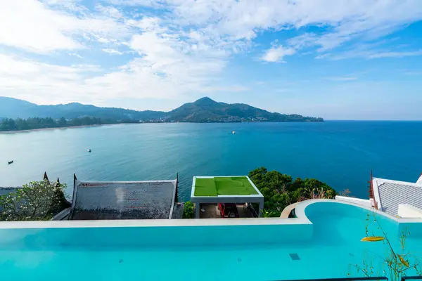 Stock image Swimming pool with stair on top of roof deck building looking at view tropical sea ,Luxury beach villa house with sea view swimming pool in modern design,Summer Vacation and travel background concept