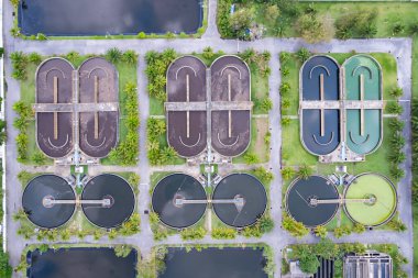 Top down drone shot of the sewage treatment plant.The Solid contact clarifier tank type sludge recirculation in water treatment plant. Industrial wastewater treatment plant clipart