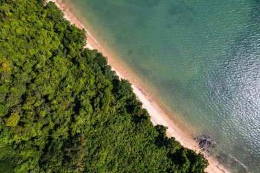 Aerial view of a blue sea surface water texture background,Sun reflections over ocean, Aerial flying drone view Waves water surface texture on sunny tropical ocean in Phuket island Thailand