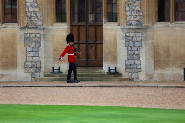 İngiliz Kraliyet Muhafızları 'nın Windsor Kalesi' nde kırmızı üniforma ve ayı postu şapkası giymesi İngiliz kraliyet ailesinin simgesi ve Londra 'da bir turizm simgesidir.