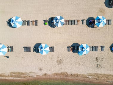 Aerial view of beach with sun umbrellas on a lake clipart