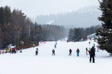 Karakol, Kırgızistan - 21 Ocak 2024: Kayakçılar ve teleferik