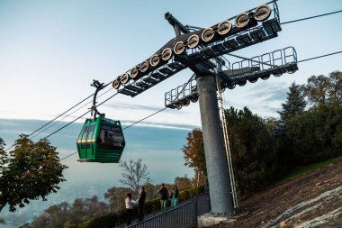 Almaty, Kazakistan - 27 Ekim 2023: Almaty Kazakistan sisli gününde turistler ve teleferikli Kok-tobe tepesi