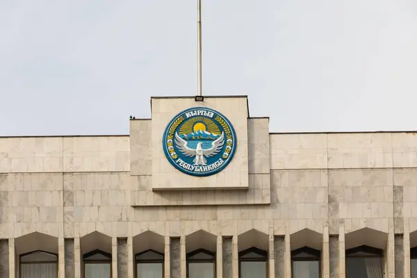 stock image Bishkek, Kyrgyzstan - October 21, 2021: National emblem of Kyrgyzstan on the building of The White House