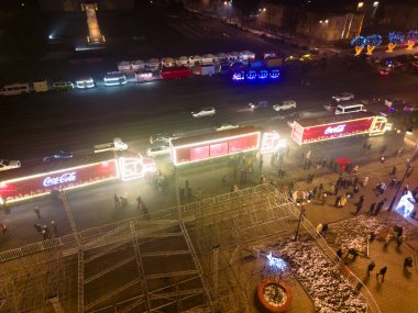 Bishkek, Kırgızistan - 24 Aralık 2022: İnsanlarla dolu bir meydanda Coca-Cola kamyonlarının hava manzarası