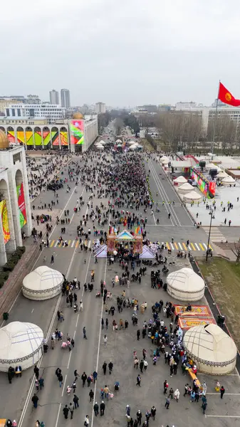 stock image Bishkek, Kyrgyzstan - March 21, 2024: Aerial view of people celebrating Nowruz on central square of Bishkek city. Nowrus is a holiday of the arrival of spring and the New Year according to the astronomical solar calendar