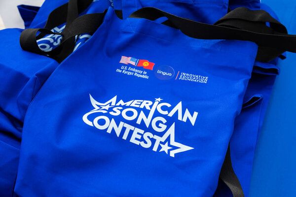 Bishkek, Kyrgyzstan - June 27, 2024: Close-up of blue American Song Contest promotional bags with logos of US Embassy