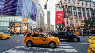 NEW YORK, ABD - 15 Ekim 2022: Sarı taksiler ve mağazalar ile New York 'un işlek caddesi