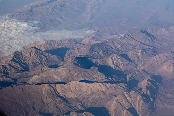 stock image Aerial view of mountain ridges with shadows and light