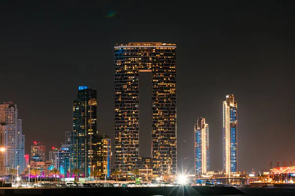 stock image Dubai, United Arab Emirates - March 3, 2024: Night view of the Address Beach Resort Tower illuminated, dominating the Dubai Marina skyline