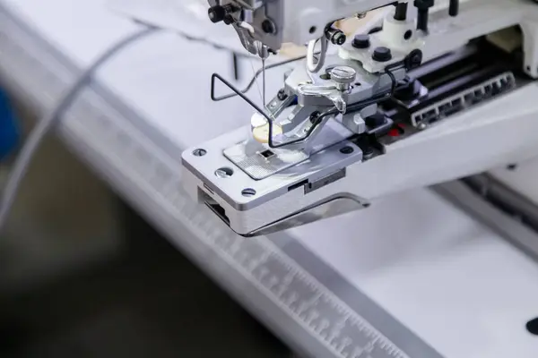 Close up of button on electric sewing machine