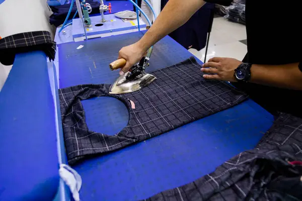 stock image Tailor ironing clothes in tailoring shop with steam Iron