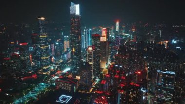 Guangzhou, Çin - 18 Nisan 2024: Guangzhou gökdelenlerinin havadan görünüşü, gece gökyüzüne karşı sayısız ışıkla parlıyor