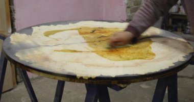 Carpenter coating wooden epoxy table with linseed oil. Process of making wood table