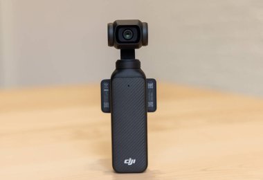 Bishkek, Kyrgyzstan - November 4, 2024: Rear view of DJI Osmo Pocket 3 showing camera lens on wooden surface clipart