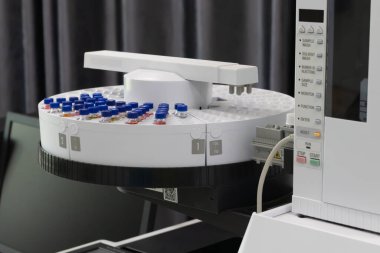 Automated laboratory sample handling system with vials in gas chromatography autosampler carousel. Modern scientific research and pharmaceutical testing equipment for chemical analysis