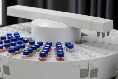 Automated laboratory sample handling system with vials in gas chromatography autosampler carousel. Modern scientific research and pharmaceutical testing equipment for chemical analysis