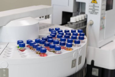 Automated laboratory sample handling system with vials in gas chromatography autosampler carousel. Modern scientific research and pharmaceutical testing equipment for chemical analysis