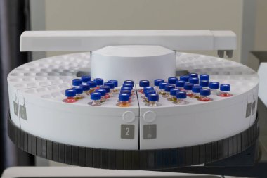 Automated laboratory sample handling system with vials in gas chromatography autosampler carousel. Modern scientific research and pharmaceutical testing equipment for chemical analysis