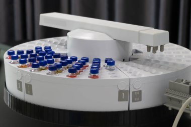Automated laboratory sample handling system with vials in gas chromatography autosampler carousel. Modern scientific research and pharmaceutical testing equipment for chemical analysis