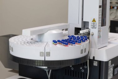Automated laboratory sample handling system with vials in gas chromatography autosampler carousel. Modern scientific research and pharmaceutical testing equipment for chemical analysis