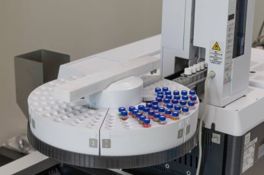 Automated laboratory sample handling system with vials in gas chromatography autosampler carousel. Modern scientific research and pharmaceutical testing equipment for chemical analysis