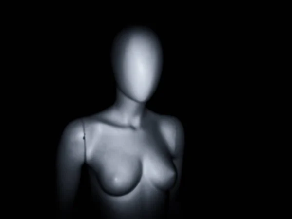 Female naked mannequin. Black and white blurred human mannequin. Close-up of a plastic mannequin head and body. Black and white plastic and artificial mannequin.