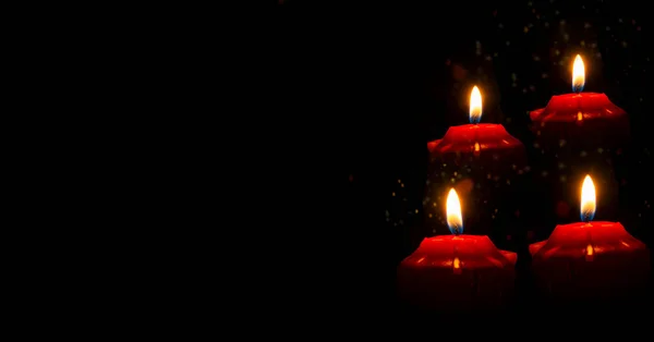 Red candles with mysterious light on dark banner.