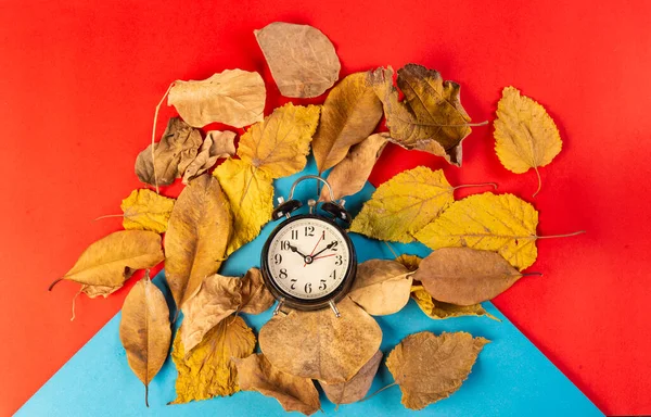 Its autumn time theme with yellow leaves and clock on red banner template.
