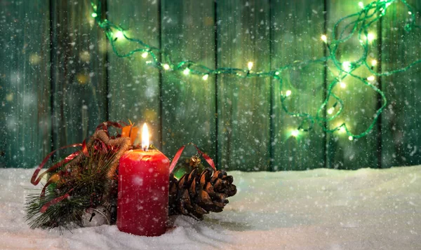 Christmas and winter theme with snow and lights in background wood.