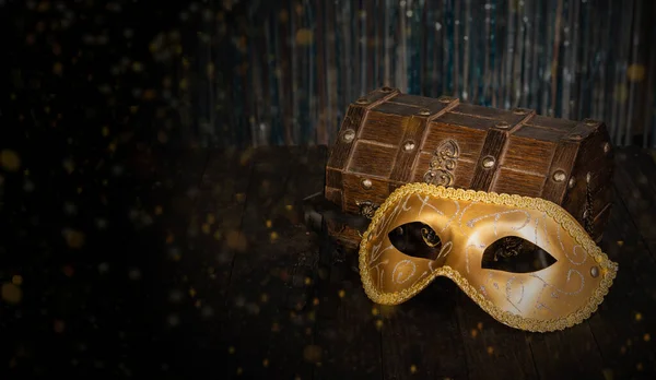 Vintage carnival mask with treasure box and sparkles.