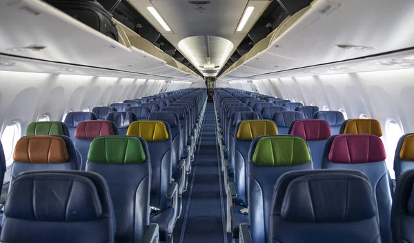 stock image Empty Airplane inside cabin view with colorful seats - travel theme.