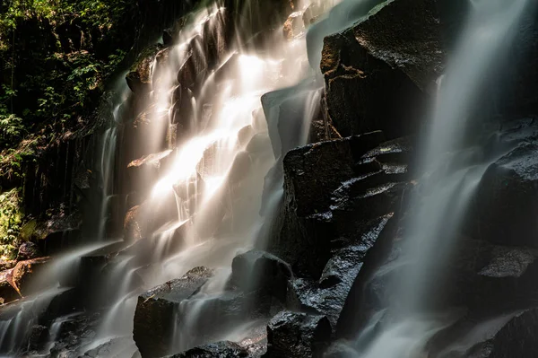 Beautiful black rocks and waterfall long exposure photography.