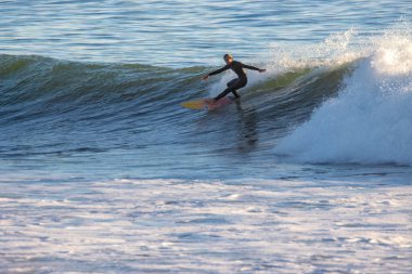Kaliforniya 'nın Ventura caddesinde büyük kış dalgalarında sörf yapmak