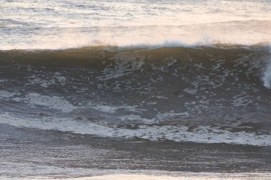 Surfing Giant waves on West Beach in Santa Barbara